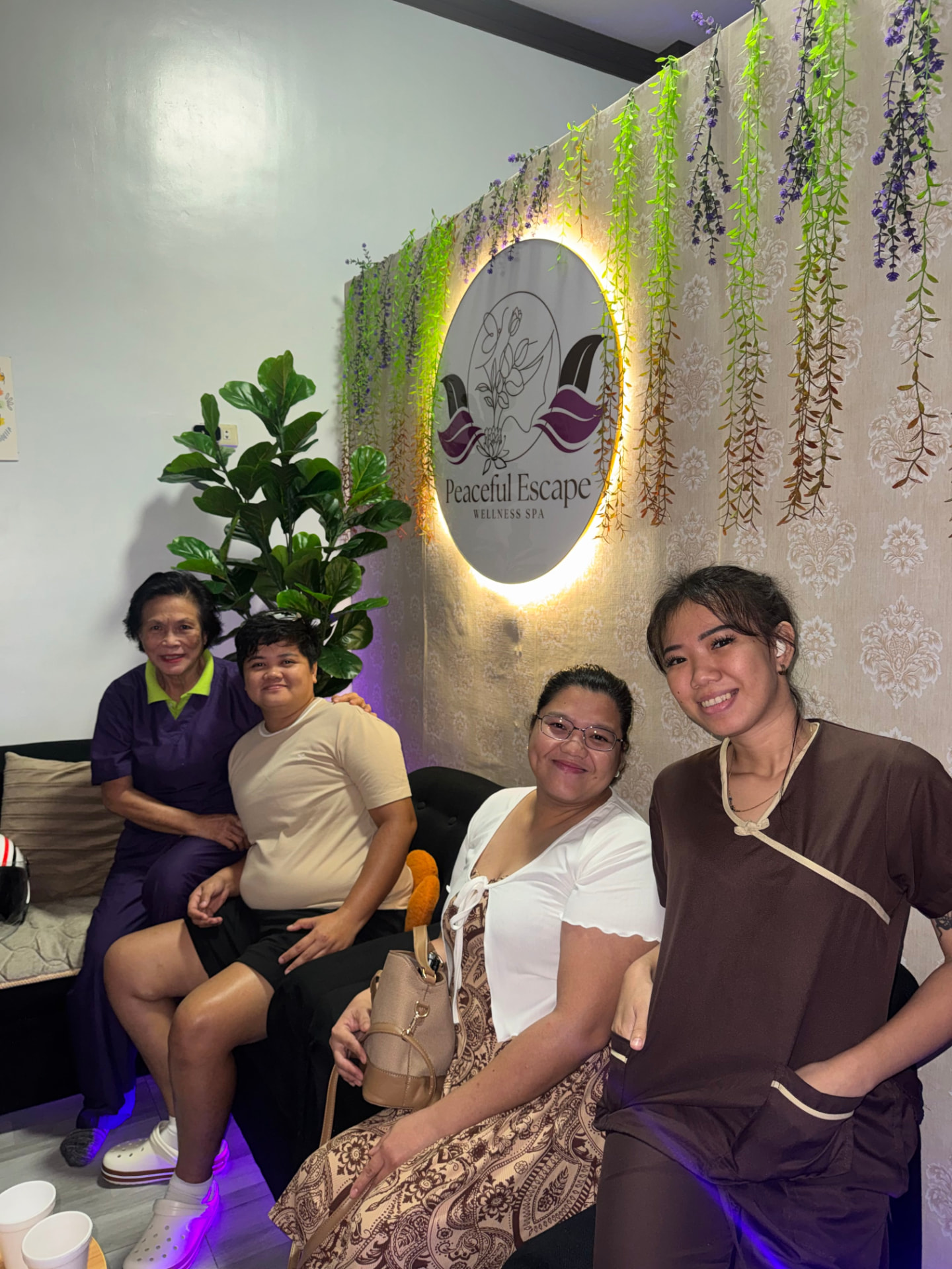 Happy guests with our therapist in the spa lounge